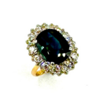 GREENISH BLUE OVAL SAPPHIRE AND DIAMOND PLATINUM AND GOLD RING